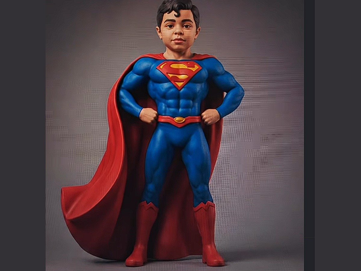 Custom 3D printed Superman figurine with a client's facial features, painted in blue, red, and yellow