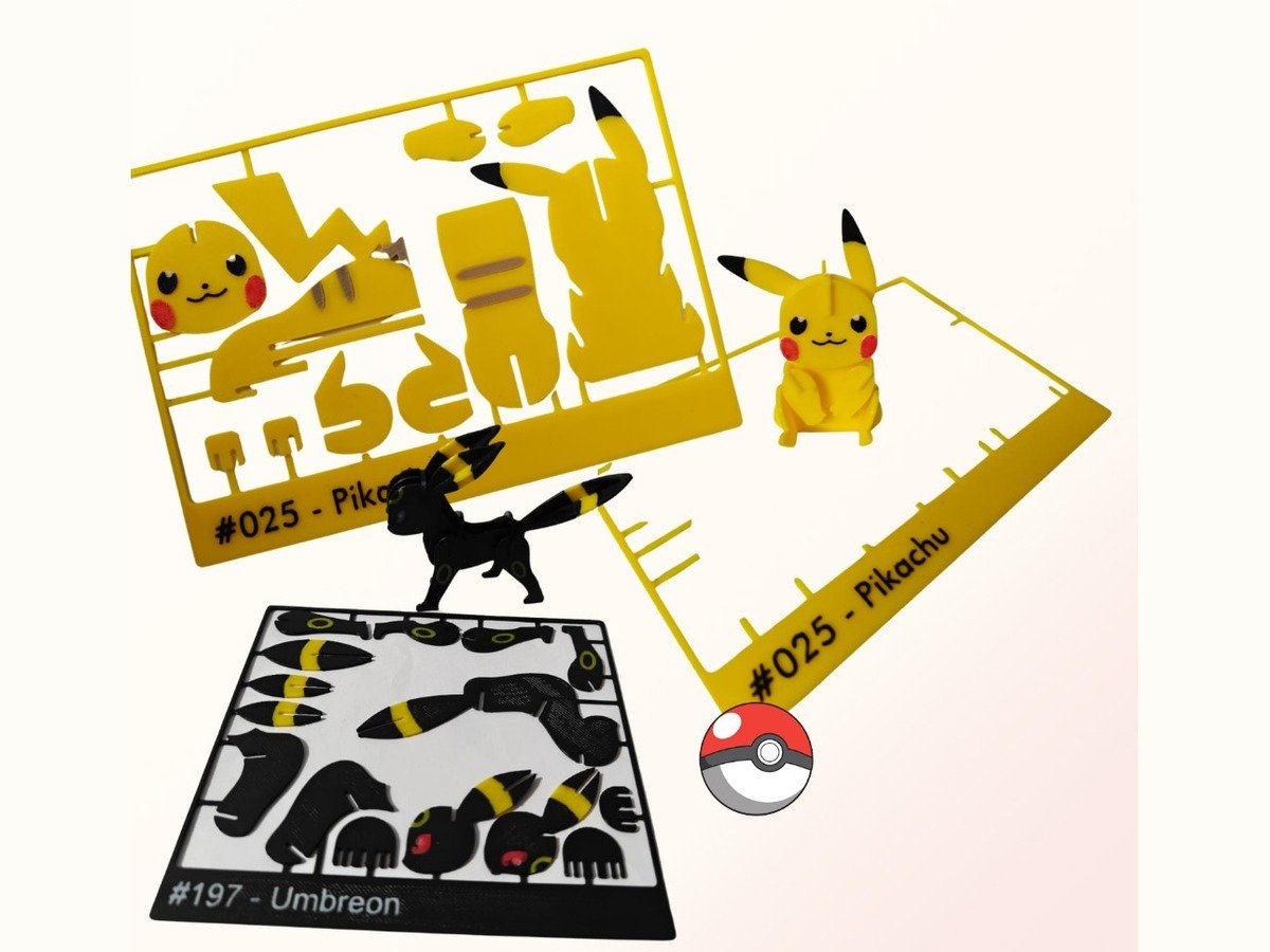Yellow Pikachu and black Umbreon 3D printed DIY kits together, each with an assembly card and finished figure